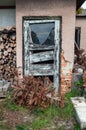 Dilapidated broken wooden door on a small house. Royalty Free Stock Photo