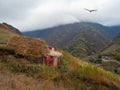 Dilapidated building, a barn in a mountainous area on a steep slope. Foggy mountain landscape of Ingushetia Royalty Free Stock Photo