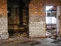 A dilapidated building interior with weathered brick walls, damaged structure, and a gloomy atmosphere Royalty Free Stock Photo