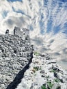 Dilapidated castle on the mountain, ruins and blue sky