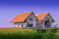 Dilapidated of landmark twin house at Talaynoi with blue sky, Chaloem Phrakiat Bridge, Phattalung in Thailand