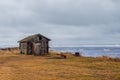 A dilapidated old fisherman`s cottage in an authentic village on the shore of the White sea. Kola Peninsula