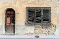 Dilapidated old house front with broken window shutters Royalty Free Stock Photo