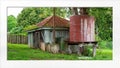 Dilapidated Old Shed And Water Tank Framed With White Matting Royalty Free Stock Photo