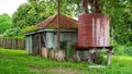 Dilapidated Old Shed And Water Tank Royalty Free Stock Photo