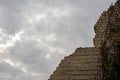 A half-destroyed part of the brick wall of the building is intended for demolition against the background of a cloudy sky Royalty Free Stock Photo