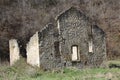 Dilapidated stone building in a field. Old mill in the fall. A stark background Royalty Free Stock Photo