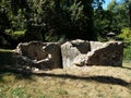 Dilapidated stone building with grass and trees