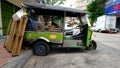 Dilapidated tuk tuk taxi on a Bangkok street Royalty Free Stock Photo