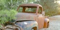 Dilapidated vehicle in the forest on a sunny day Royalty Free Stock Photo