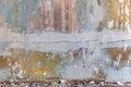 Dilapidated wall of a room with layers of paint, pieces of wallpaper Royalty Free Stock Photo