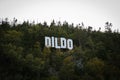 Dildo, a small fishing village in Newfoundland, Town sign on hillside. Royalty Free Stock Photo