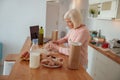 Diligent aged woman cooking at home kitchen