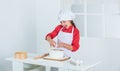 diligent approach. happy child cooking in kitchen. bake cookies in kitchen. professional and skilled baker. kid in chef Royalty Free Stock Photo