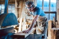 Carpenter working on wood with the circular saw Royalty Free Stock Photo