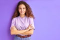 Diligent caucasan curly young girl posing with crossed arms Royalty Free Stock Photo