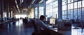 Diligent coder, programmer, office worker employee in a huge office workplace, room with large windows. Working alone.