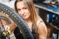 Diligent female mechanic wiping fuel oil in the garage