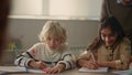 Schoolchildren writing in notebooks. Students making notes in exercise books Royalty Free Stock Photo