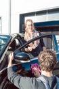 Diligent service man helping woman cleaning her car in commercial wash Royalty Free Stock Photo