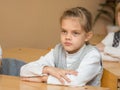 Diligent student in classroom listening to a teacher at school