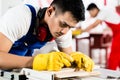 Diligent worker in factory working on wood