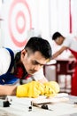 Diligent worker in factory working on wood Royalty Free Stock Photo