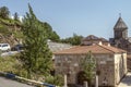 Courtyard of the monastery of Haghartsin overlooking the restored Church of the Blessed Holy Mother in the mountains covered wit