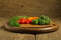 dill. baby tomatoes. carrot. broccoli. on old chopping borad woo