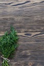 Dill bunch on rustic wood background.