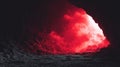 Ethereal Cloud Formation in Dark Cave Entrance Tunnel with Fiery Red Light Effect Royalty Free Stock Photo