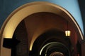 A dim lamp illuminates the ancient arcade