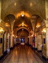 A dim lit marble hallway with elaborate decoration.