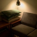 A dim shaded view of sofa with a stack of pillows.