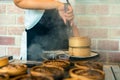 Dim sum in bamboo steamer chinese cuisine. close up woman female hands holding tongs choosing meal delicious food in wood basket Royalty Free Stock Photo