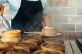 Dim sum in bamboo steamer chinese cuisine. close up woman female hands holding tongs choosing meal delicious food in wood basket Royalty Free Stock Photo