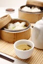 Dim sum in bamboo steamers with a pot of chinese tea. Conceptual image