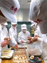 Chefs are cooking Chinese dumplings by the traditional bamboo steamers in a restaurant.