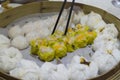 Dim Sum dumplings with steamed buns in the container and chopsticks Royalty Free Stock Photo