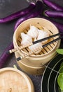 Dim sum dumplings in steamer with traditional chinese vegetables