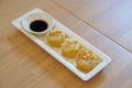 Dim Sum Recipe - Chinese shrimp dumplings topped with fried garlic, served with sour sauce. Royalty Free Stock Photo