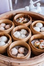 Dim sum set: Barbecued pork bun, Shrimp dumpling, Sweet cream buns, Shrimp shumai topping with goji berry served in steamer basket Royalty Free Stock Photo