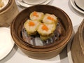 Dim Sum Steamed Pork Dumplings (Shu Mai) in bamboo steamer. Yumcha, Cantonese food style. Chinese cuisine. Royalty Free Stock Photo
