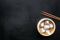 Dim sums with red pepper and vegetables with sticks in Chinese restaurant on black background top view mockup Royalty Free Stock Photo