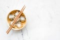 Dim sums with red pepper and vegetables with sticks in Chinese restaurant on marble background top view mockup Royalty Free Stock Photo