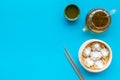 Dim sums with sticks and herbal tea in Chinese restaurant on blue background top view mockup Royalty Free Stock Photo