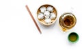 Dim sums with sticks and herbal tea in Chinese restaurant on white background top view mockup Royalty Free Stock Photo