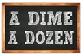 A DIME A DOZEN words on black wooden frame school blackboard