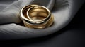 Dimensional Multilayering: Gold Wedding Rings On Gray Cloth