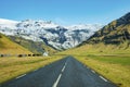 Diminishing empty road leading towards snowcapped mountain against clear blue sky Royalty Free Stock Photo